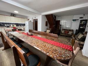 a large wooden table in a room with chairs at Pensiunea Aurora Vartop in Vartop