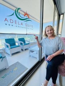 a woman sitting in a chair in a room at Adela Suite in Santa Marta