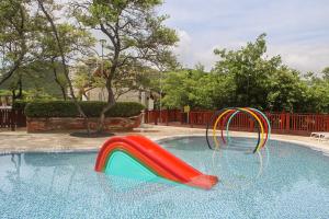 a swimming pool with a colorful slide in it at Adela Suite in Santa Marta