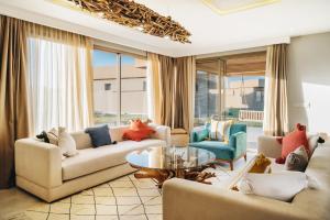 a living room with two couches and a table at Tulum Beach Resort Dakhla in Dakhla