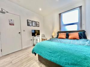 a bedroom with a large bed and a window at Dunamis Staycation 4 in Croydon