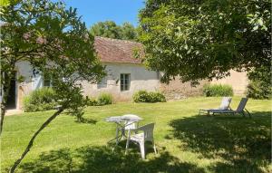 a table and chairs in the yard of a house at Cozy Home In St Jean Aux Amognes in Nanton