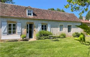 an old stone house with a yard at Cozy Home In St Jean Aux Amognes in Nanton