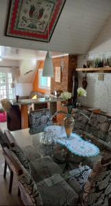 a dining table and chairs in a living room at Chalé São Rafael - Recanto da Natureza in Gramado