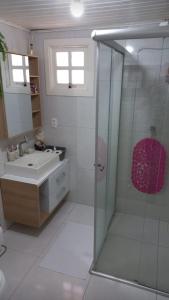 a bathroom with a shower and a sink at Chalé São Rafael - Recanto da Natureza in Gramado