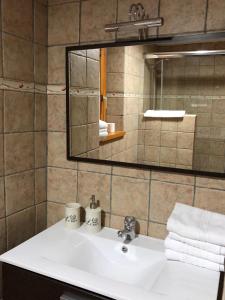 a bathroom with a white sink and a mirror at Apartamentos Ca de Marti in Bohí