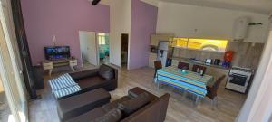 a living room with a couch and a table at Casa Las Lavandas - LOS REYUNOS in San Rafael