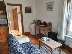 a living room with a couch and a table at Cosy self contained cottage with stunning views in Killaloe