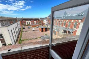 an open window with a view of a parking lot at Gold Penthouse - Near Basingstoke hospital 2min in Sherborne Saint John