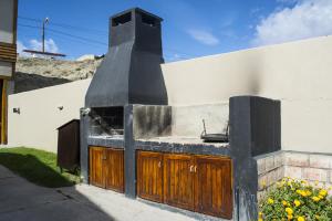 a building with a stove on the side of it at Apart Haiken in El Calafate