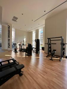 a gym with treadmills and machines in a room at Torre Milano - Luxury modern flat in Milan