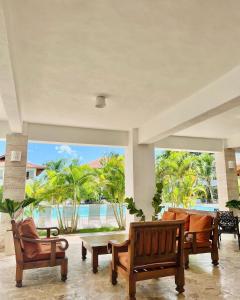 a living room with chairs and a view of the ocean at Paraíso Bayahibe in Bayahibe