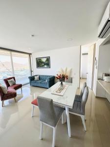 a living room with a white table and chairs at Adela Suite in Santa Marta