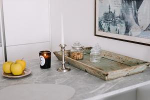 a table with a candle and a plate of fruit at Design Apartman - Free parking in Szeged