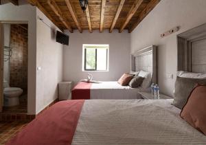 Postel nebo postele na pokoji v ubytování Hotel & Temazcal Hacienda Maxthá