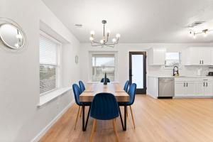 a kitchen and dining room with a wooden table and chairs at Modern & Homey 3BR Home, Remote Work Friendly, King Beds, Fast WiFi in Pflugerville +29 photos