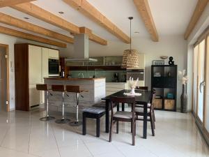 a kitchen with a table and chairs in a room at Chalet Steinernes Meer in Maria Alm am Steinernen Meer