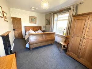 a small bedroom with a bed and a window at Mulberry Cottage in Haworth