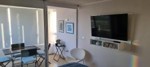 sala de estar con TV de pantalla plana en la pared en Bella Vista, en Coquimbo
