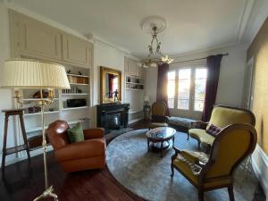 a living room with chairs and a table at Maison Pignol in Le Puy en Velay