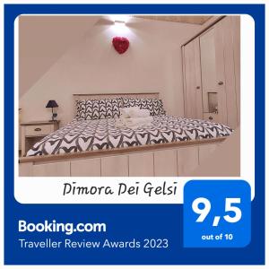 a bedroom with a bed with a black and white comforter at Dimora Dei Gelsi in Polignano a Mare