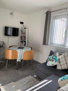 a living room with a table and a couch at Private apartment in Wrose, Shipley, Bradford in Shipley