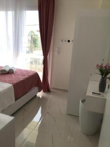 a bedroom with a bed and a large window at Estia House M in Nikiti