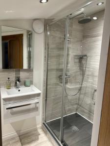 a bathroom with a shower and a sink at Brechin Townhouse - Cathedral View in Brechin