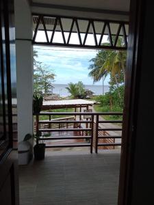 a view of the beach from a room with a balcony at MLB Beachfront Apartment in Siquijor