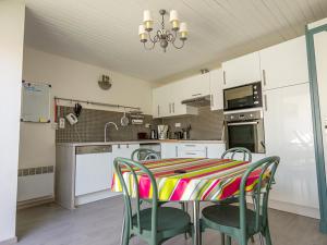 uma cozinha com uma mesa e cadeiras em Appartement Mèze, 3 pièces, 4 personnes - FR-1-604-2 em Mèze