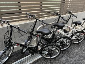 a group of bikes parked next to a bench at KLASSO Tokyo Sumiyoshi Apartments in Tokyo