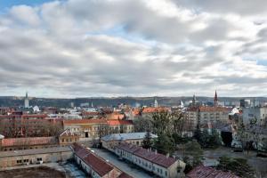 a view of a city with buildings and a cloudy sky at Moderny byt, 300 m do centra mesta in Košice
