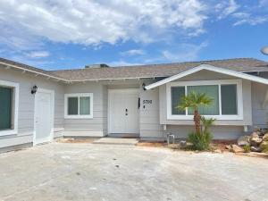 a white house with a palm tree in front of it at 3Bedroom 2Bath 15 Min to strip 10 downtown in Las Vegas