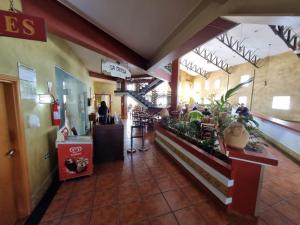 a lobby of a restaurant with a bar and a counter at Apartamento Giardino 212 sem parques in Rio Quente