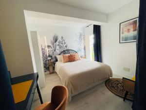 a bedroom with a bed and a chair at Mijas Loft in Mijas