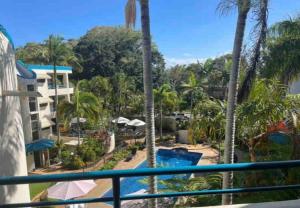 a view from a balcony of a resort with a pool at Our Beach House in Bribie Island in Bongaree