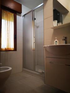 a bathroom with a shower and a toilet and a sink at Eureka Azienda Agrituristica in Cavallino-Treporti