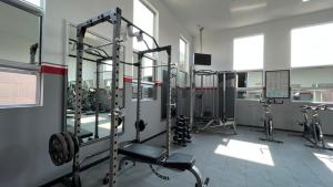 a gym with several tread machines in a room at Ramada by Wyndham Mexico City Santa Fe in Mexico City
