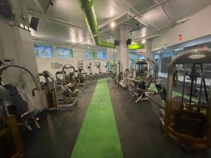 a gym with tread machines and a green floor at Broad Street Apartment in Philadelphia