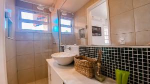 a bathroom with a sink and a mirror at Casa Vila da Praia Buzios - Centro in Búzios +43 photos