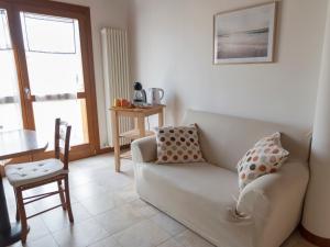 a living room with a couch and a chair at Appartamento ISOTTA in Lugo