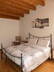 a bedroom with a bed and a wooden ceiling at Appartamento ISOTTA in Lugo