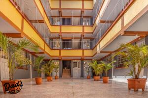 a large hallway with palm trees in a building at Dad's Place in Karatina