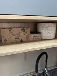 a kitchen shelf with a box of dudias on it at City Rent 1 in Osijek
