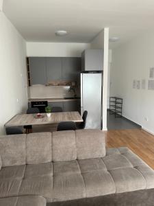 a living room with a couch and a kitchen at City Rent 1 in Osijek