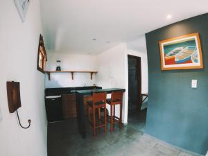 a kitchen with a counter and a sink in a room at Bangalô Patuá in Barra Grande