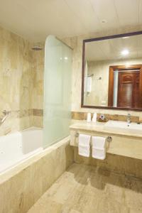 a bathroom with a tub and a sink and a mirror at Bahia Principe Grand Bavaro - All Inclusive in Punta Cana