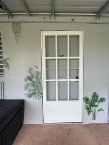 a white door on the side of a building at 2C - Couples Getaway-5 min to Crashboat Beach in Aguadilla