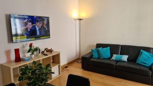a living room with a couch and a flat screen tv at 2 bedroom flat on Main Street in Gibraltar