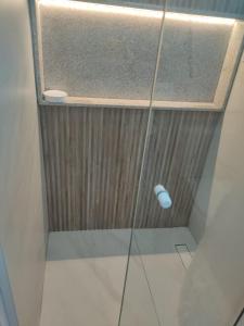 a shower with a glass door in a bathroom at Luar Porto de Galinhas in Porto De Galinhas